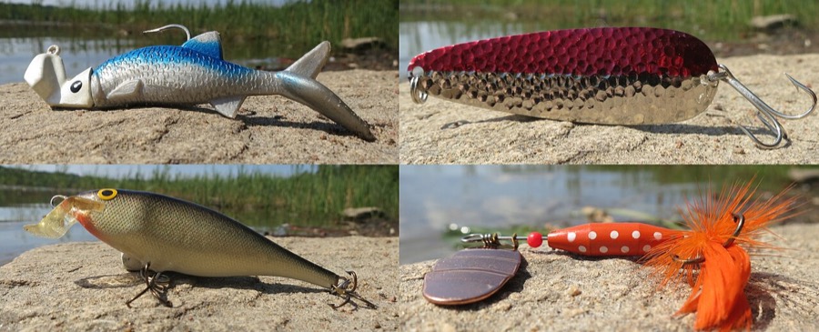 Four fishing lures photographed side by side: a jig rigged on a soft plastic
                minnow, a hammered metal spoon, a shallow crankbait with a plastic lip, and an
                inline spinner with a copper blade and an orange body.